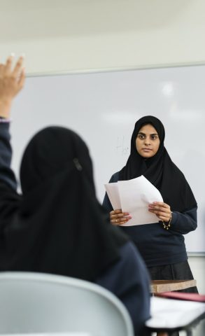 Diverse Muslim children studying in classroom